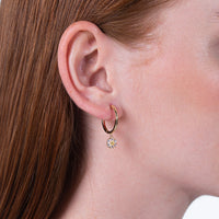 Daisy 14K earrings at the center of the ring